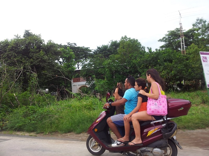 Family of 4 on a scooter in Guanacaste, Costa Rica